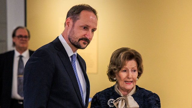 Crown Prince Haakon standing with Queen Sonja