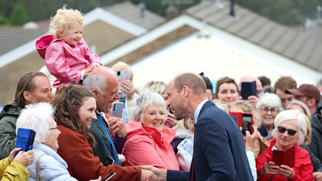 Prince William greets well-wishers while departing from a visit to Swiss Valley Community Primary School