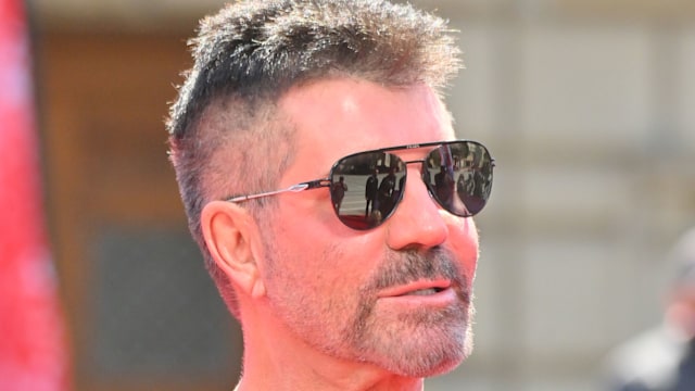 Simon Cowell in sunglasses and a dark top