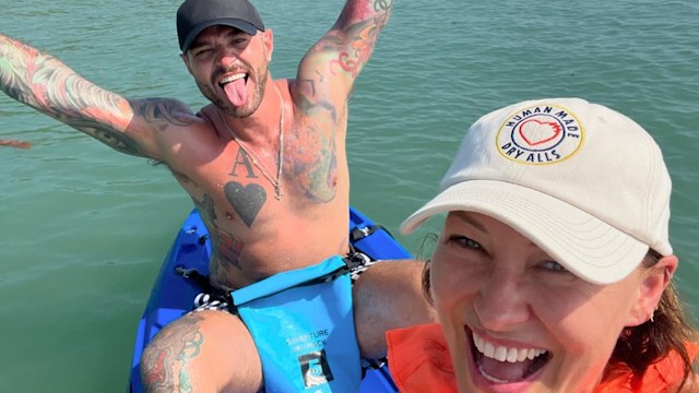 Emma and Matt Willis smiling while kayaking on the sea