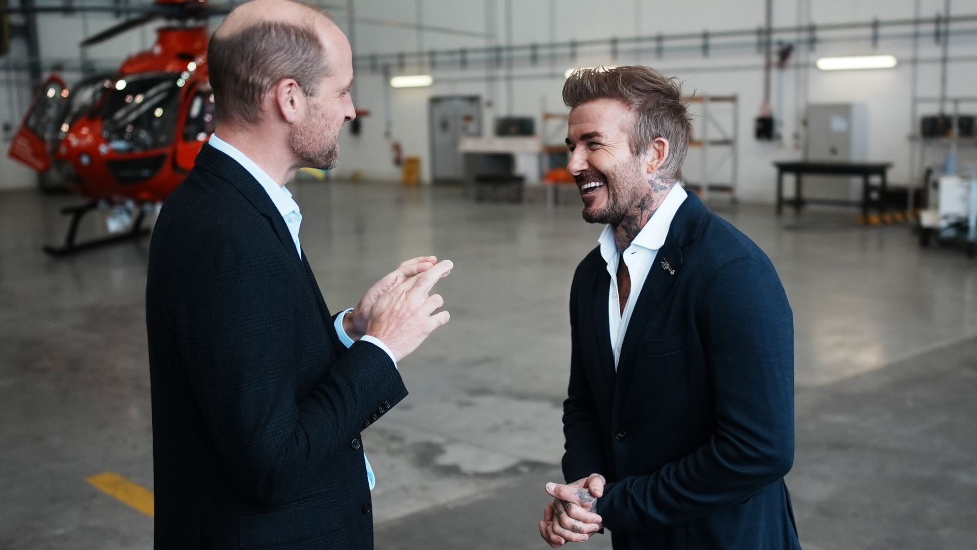 two men in suits sharing a laugh 