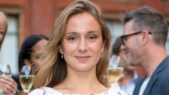 Lady Marina Windsor smiling in a white shirred dress