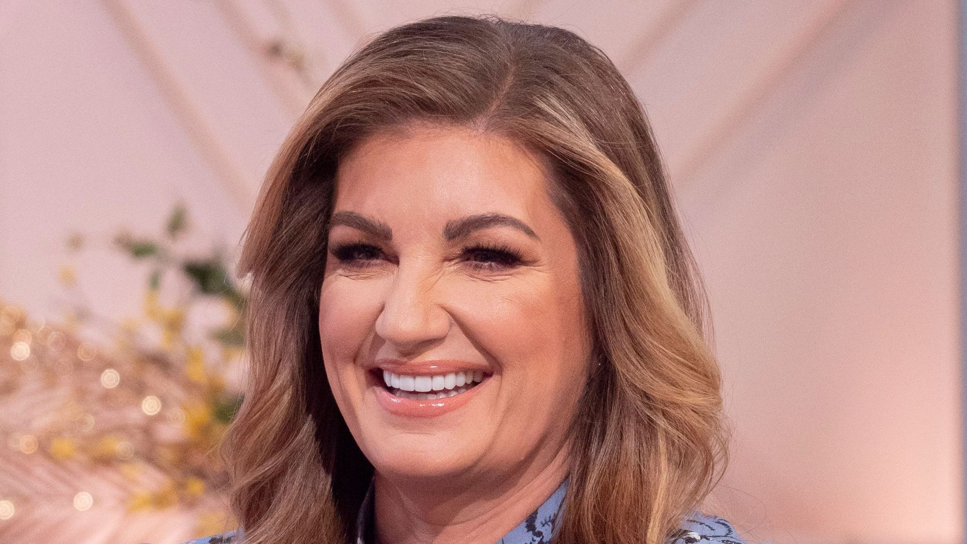 woman on sofa in blue floral dress