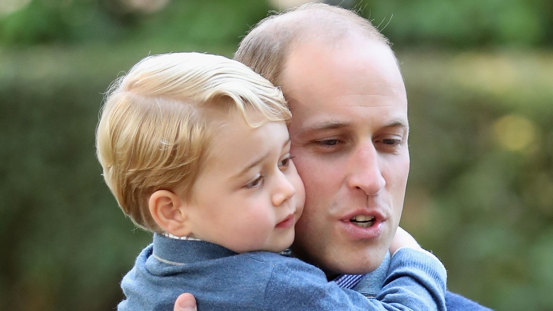 Prince George hugs his dad Prince William at a children's party for Military families during the Royal Tour of Canada