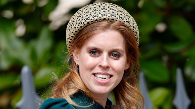 Princess Beatrice waving in a green dress