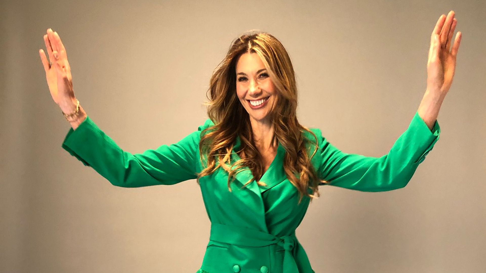 Woman in a short green dress dancing 