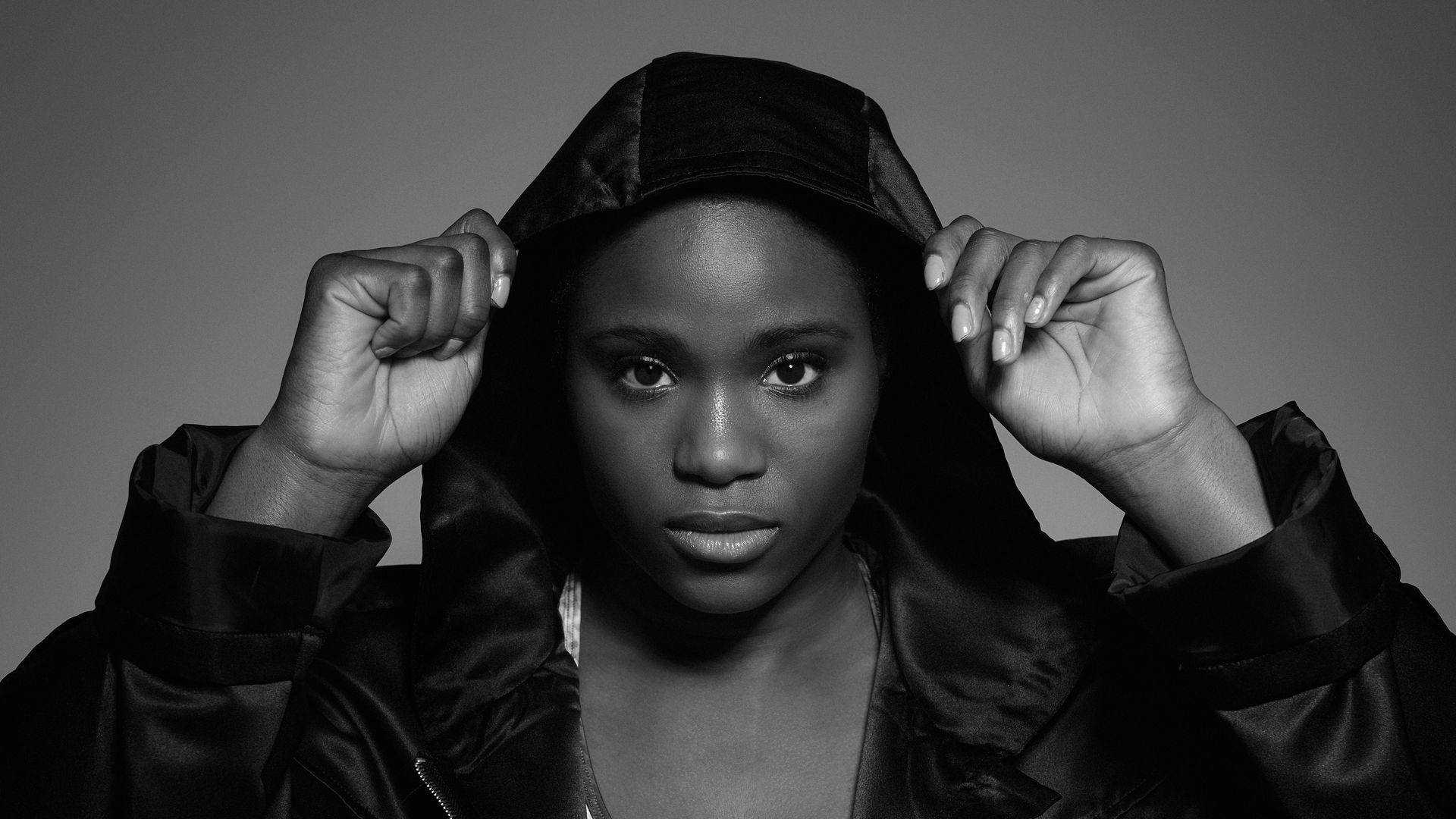 A female boxer posing with a hoodie