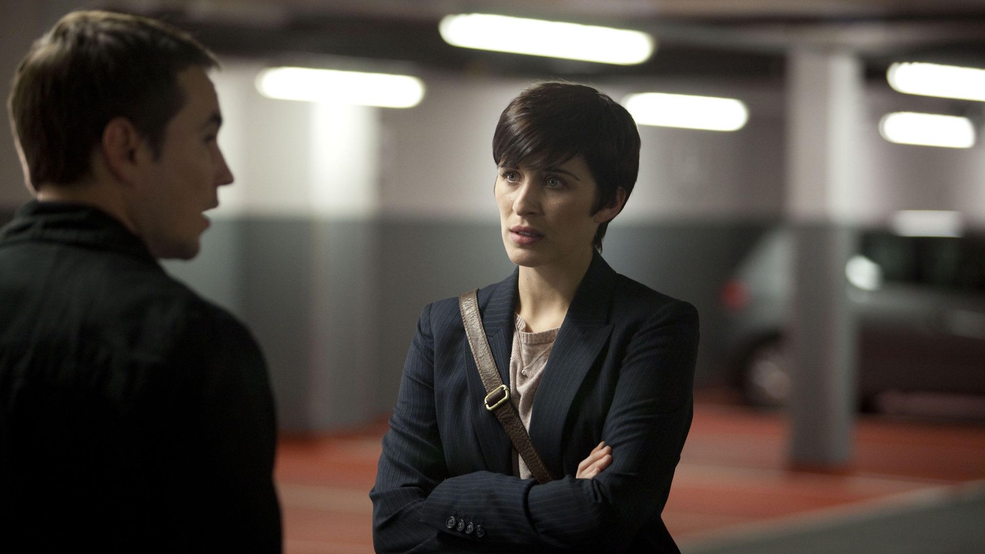 woman looking at man in underground carpark