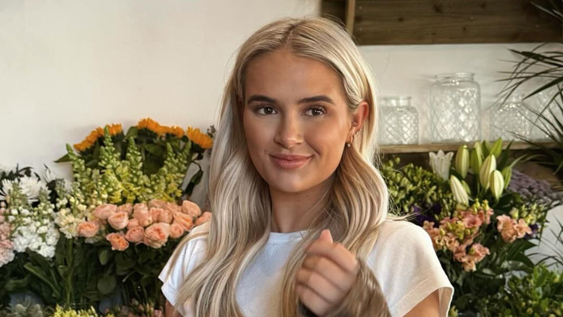 Molly mae posing with long blonde hair