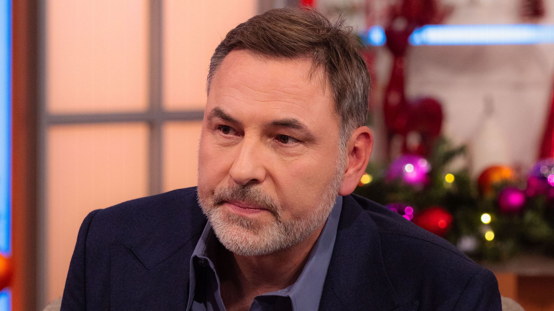 David Walliams looking sad in an armchair