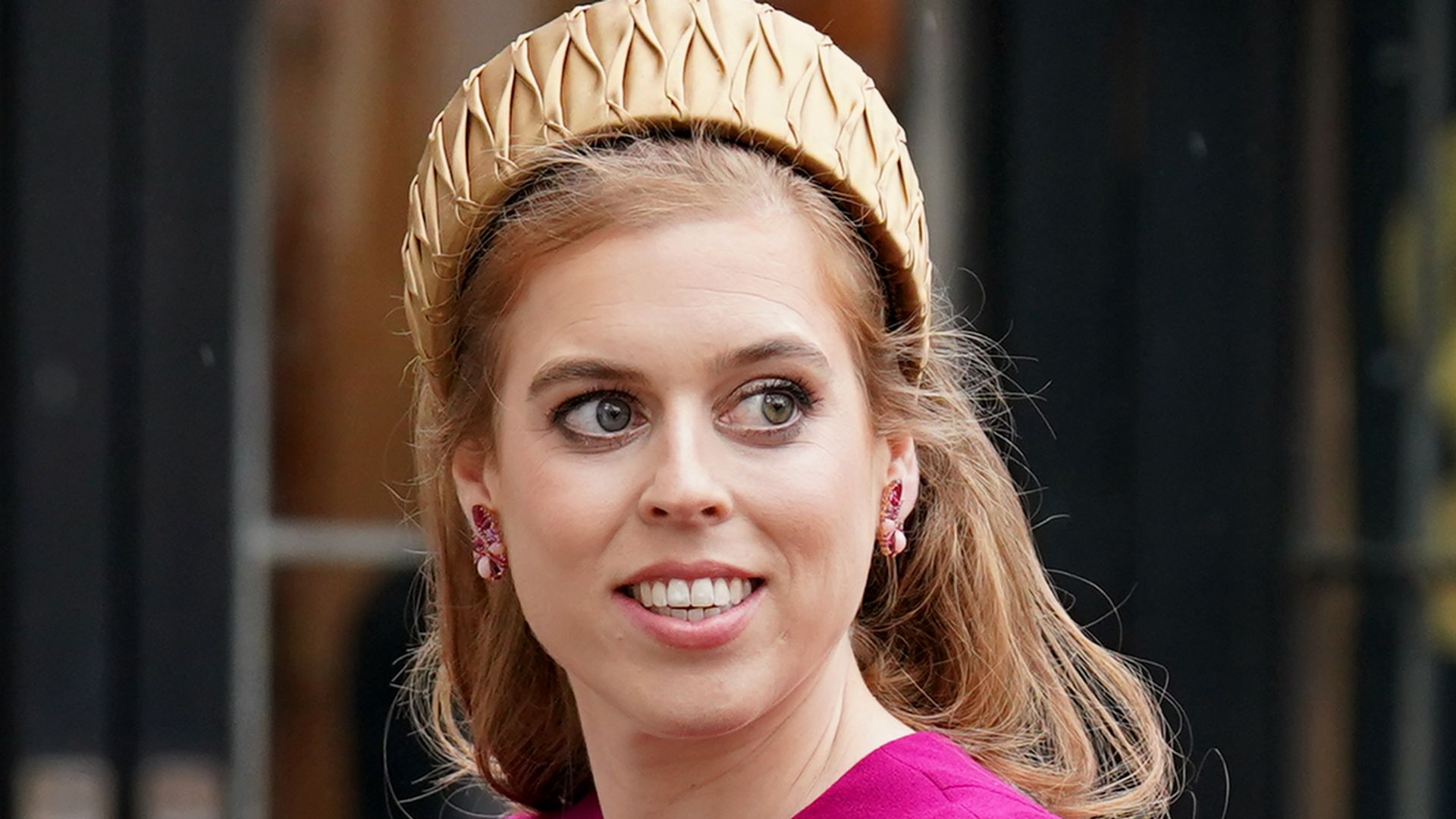 Princess Beatrice wears a puff sleeve pink dress as she arrives at Westminster Abbey beside Prince Harry