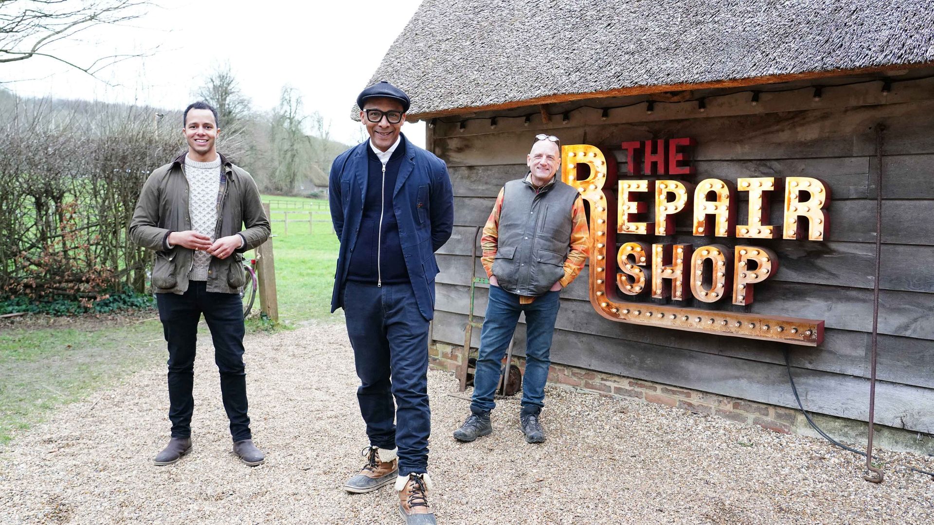 Will Kirk, Jay Blades and Steve Fletcher by The Repair Shop barn