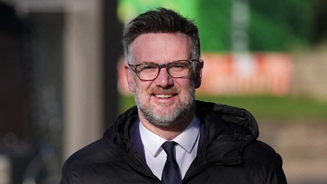 man in suit and glasses wearing coat