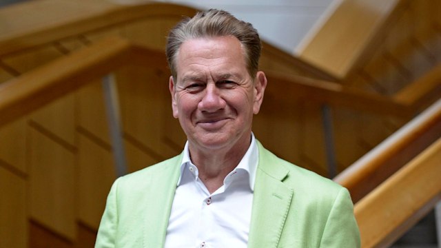 Broadcaster and former politician Michael Portillo smiles for a photo outside the the Scottish Parliament