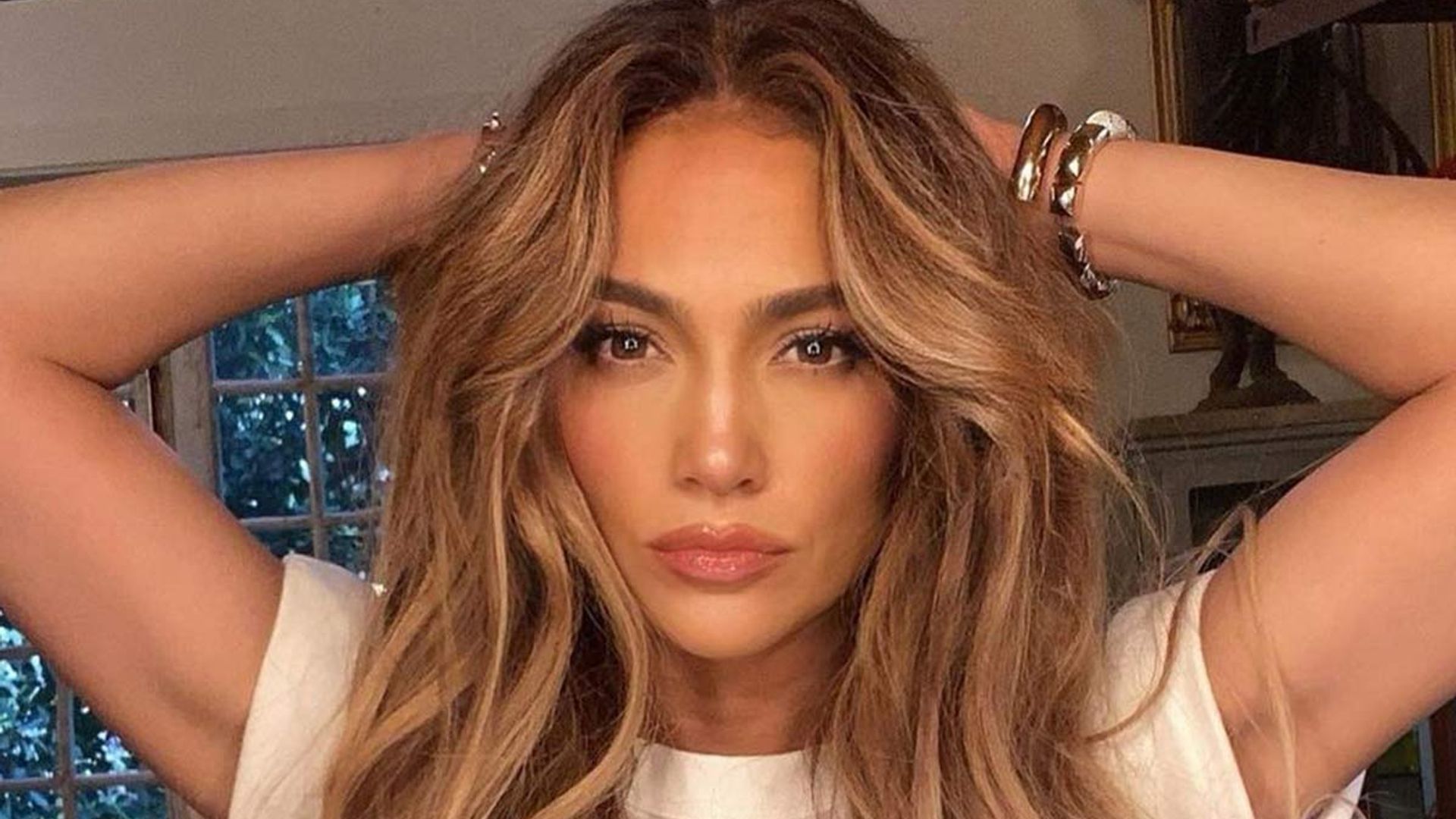 Jennifer Lopez sunbathing in a tiny white bikini makes us long for