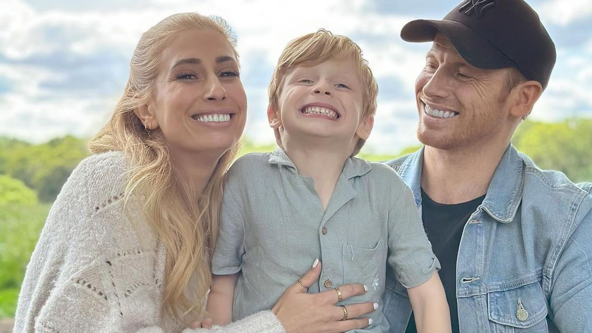 Stacey Solomon and her husband Joe Swash with their son Rex sitting on the fence