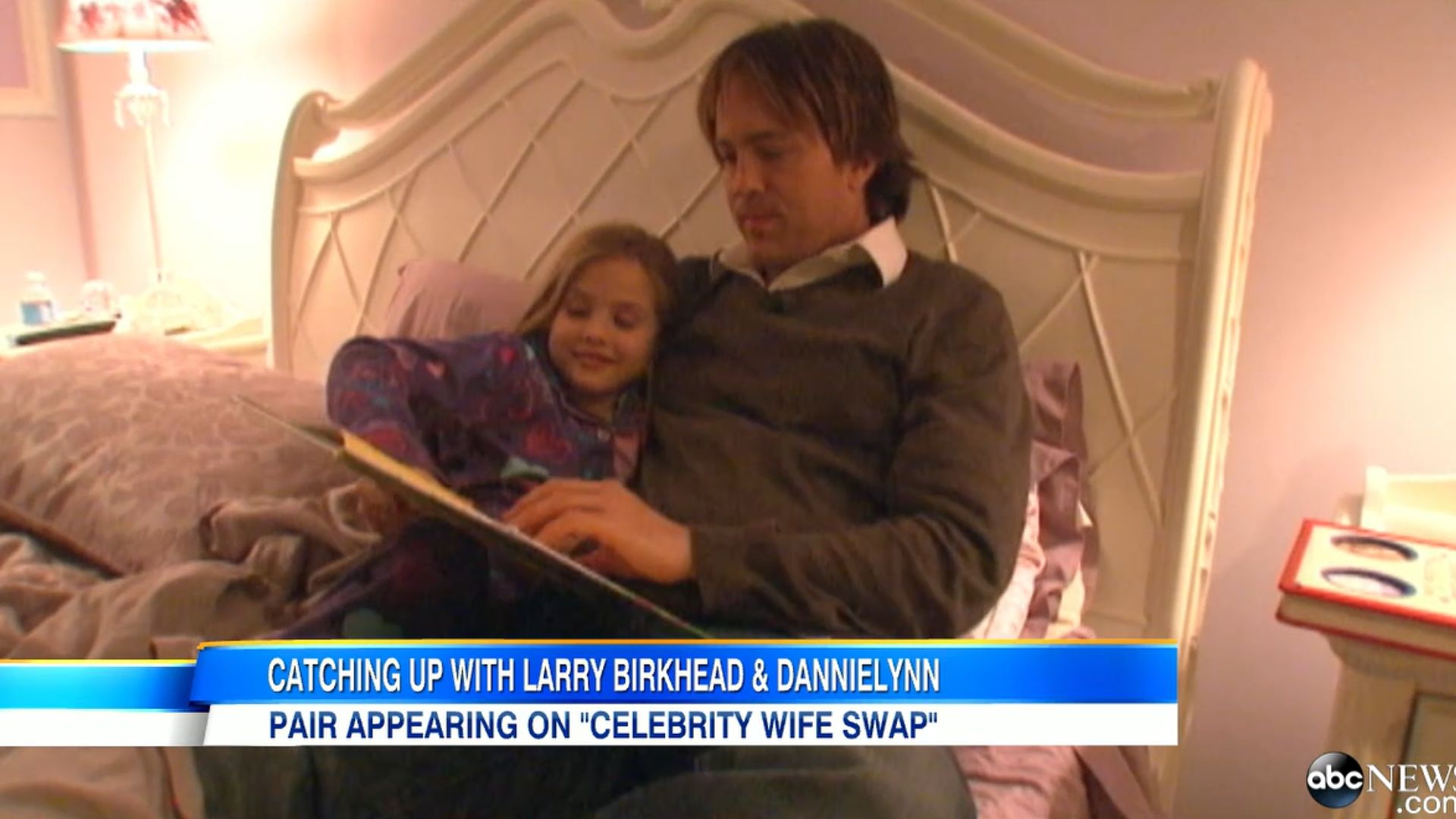 Larry and Dannielynn sat reading on her bed in her princess themed bedroom