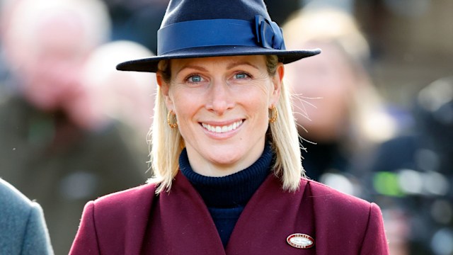 Zara Tindall in burgundy coat and blue hat