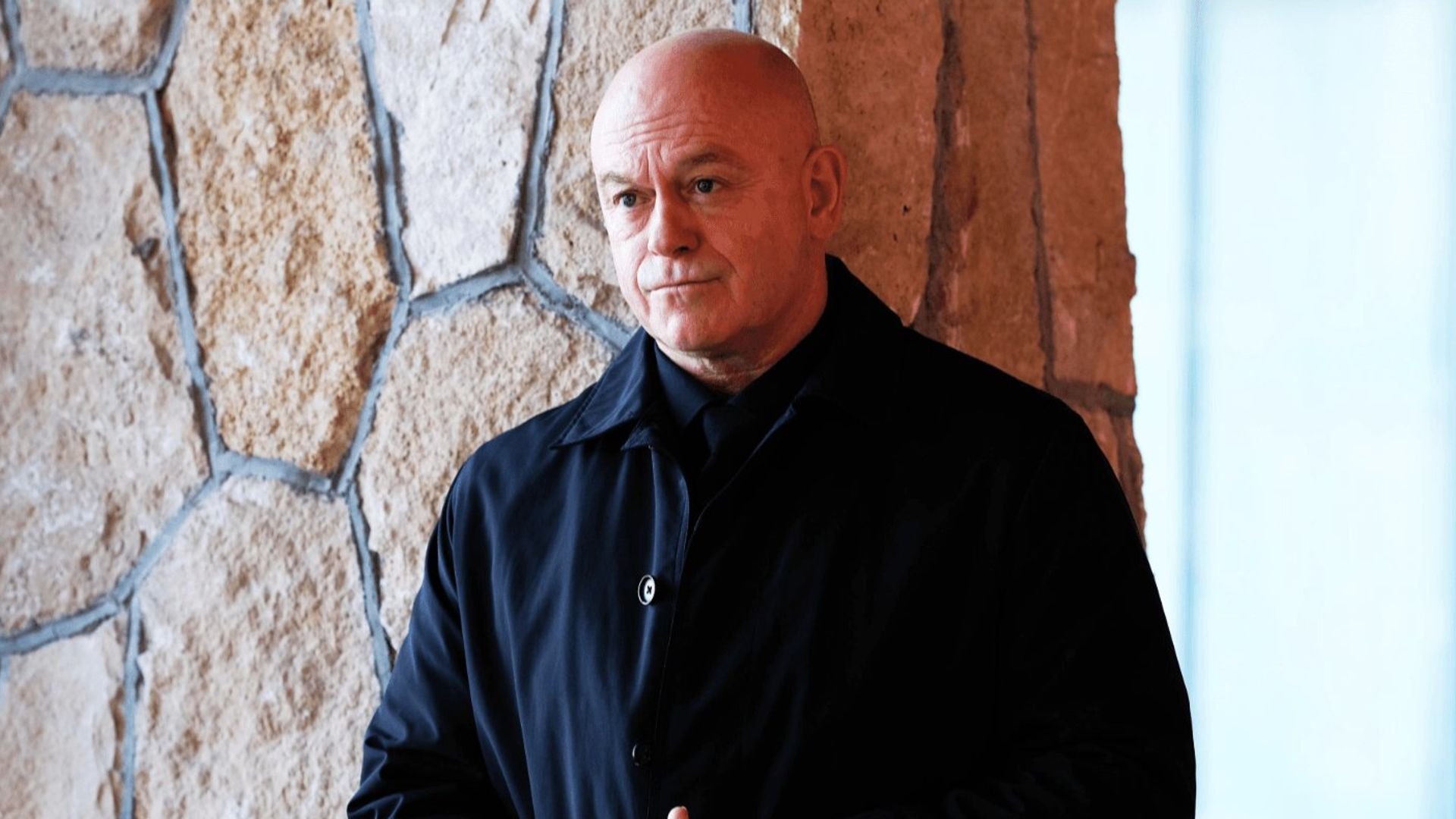 man leaning against wall