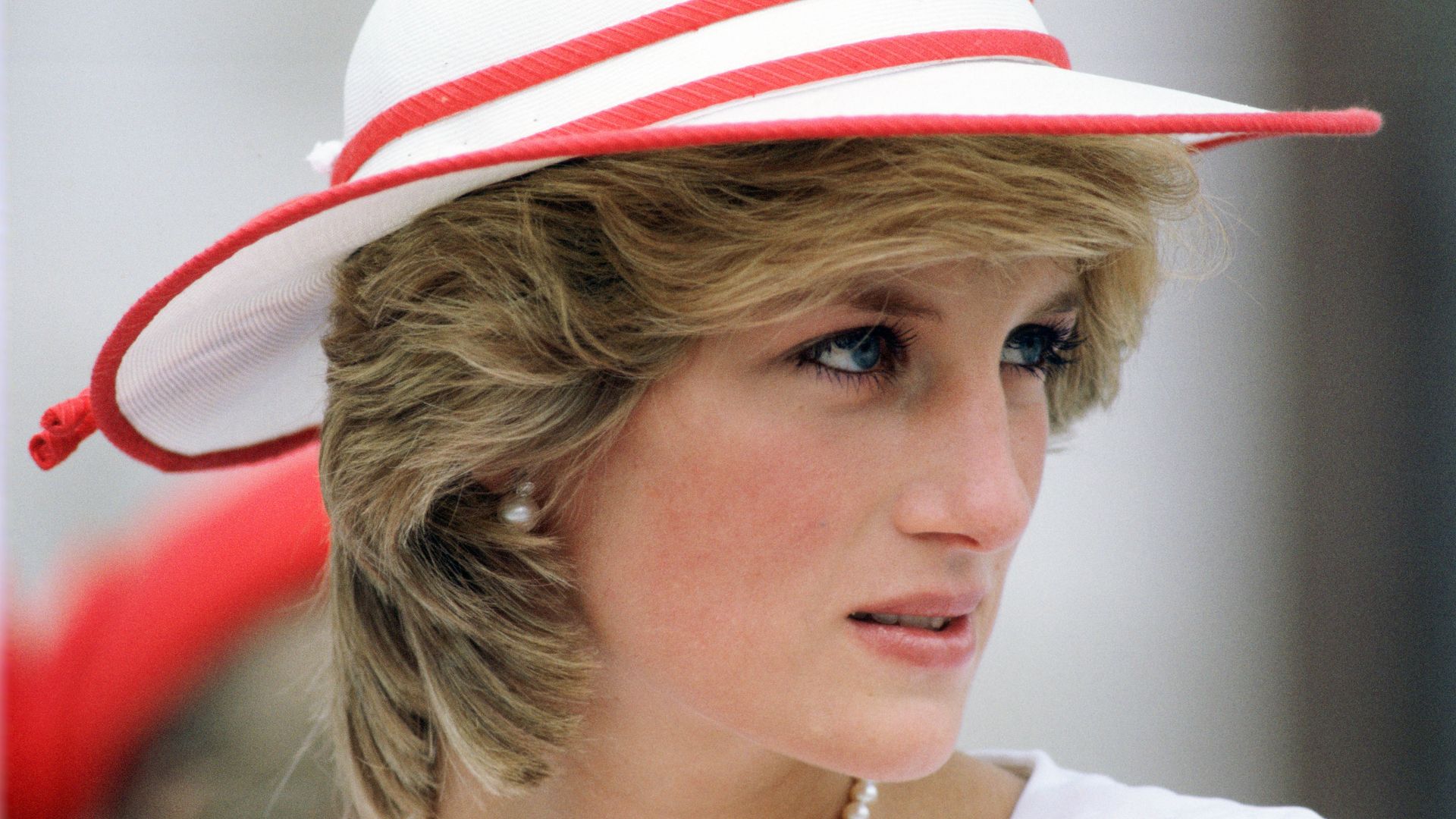 Diana, Princess of Wales looking to right in red and white hat