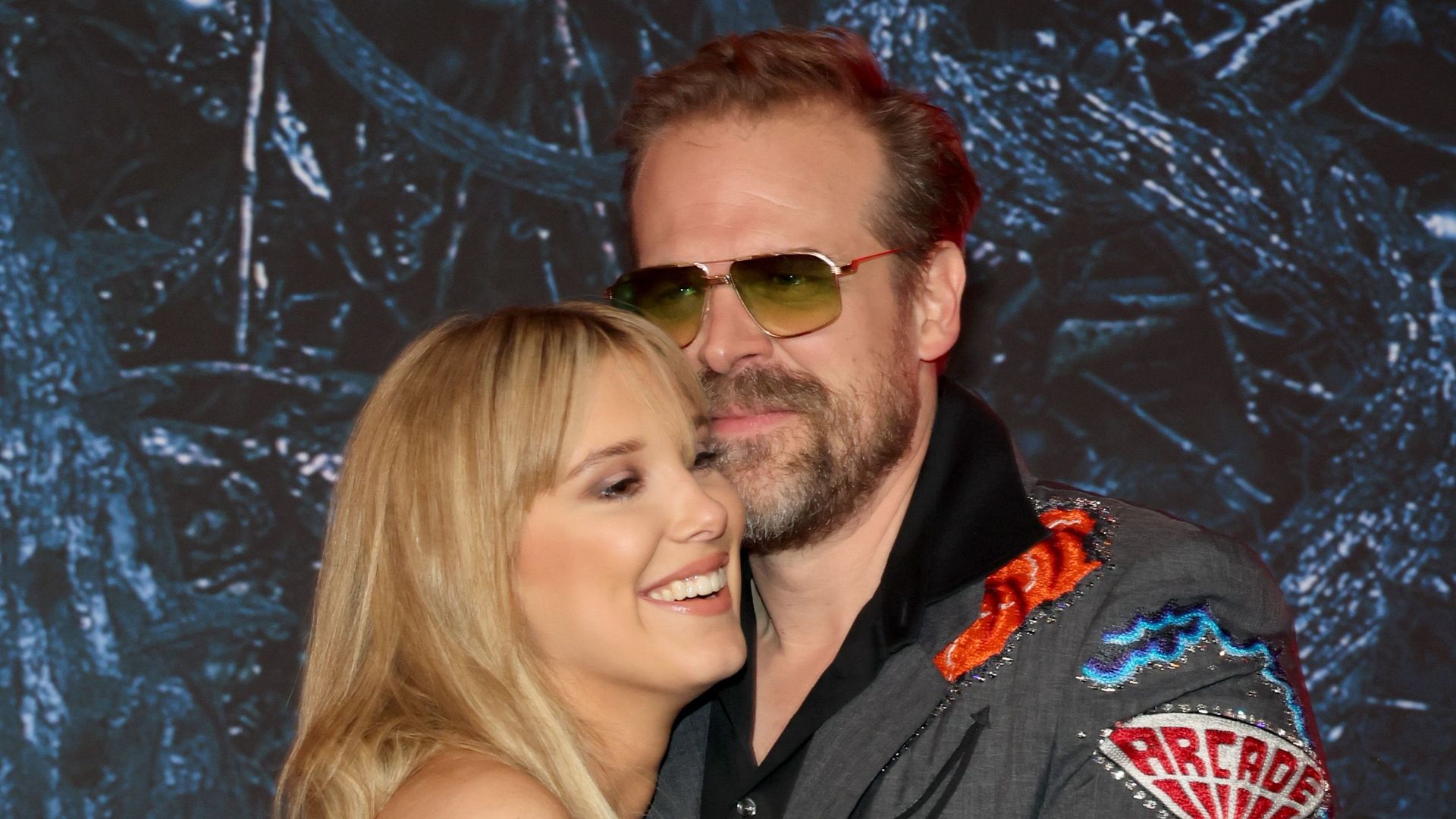 Millie Bobby Brown dazzles in lace gown as she and David Harbour reunite on Stranger Things red carpet