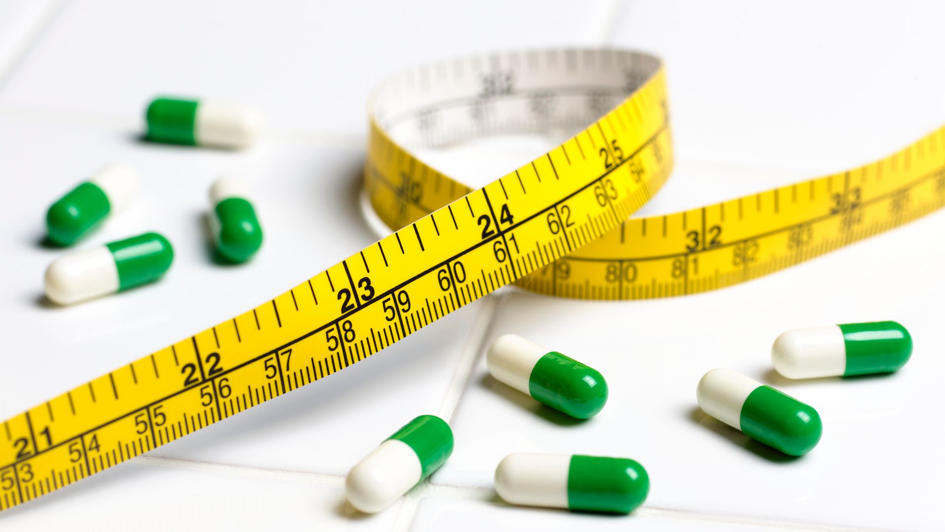 pills with tape measure stock image