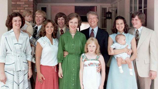 A portrait of President Jimmy Carter and his extended family. Left to right: Judy (Mrs. Jack Carter); Jason James Carter; Jack (John William Carter); Annette (Mrs. Jeff Carter); Jeff (Donnel Jeffrey Carter); First Lady Rosalynn Carter; daughter Amy Lynn Carter; President Carter; daughter-in law Caron Griffin Carter holding James Earl Carter IV; and son Chip (James Earl Carter III). 1977-1980.