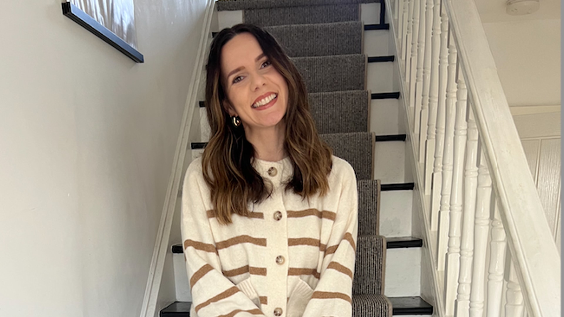 woman sat on stripy stairs
