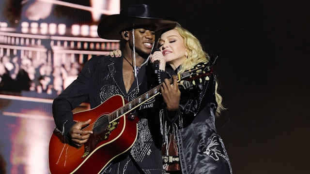 David Banda and Madonna performing on stage in cowboy inspired clothes