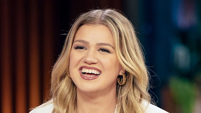 Kelly Clarkson smiling in white top 
