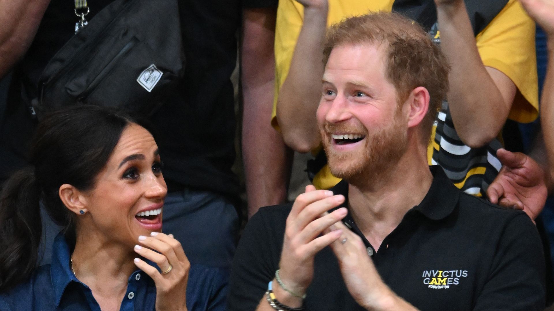 Meghan Markle and Prince Harry applauding