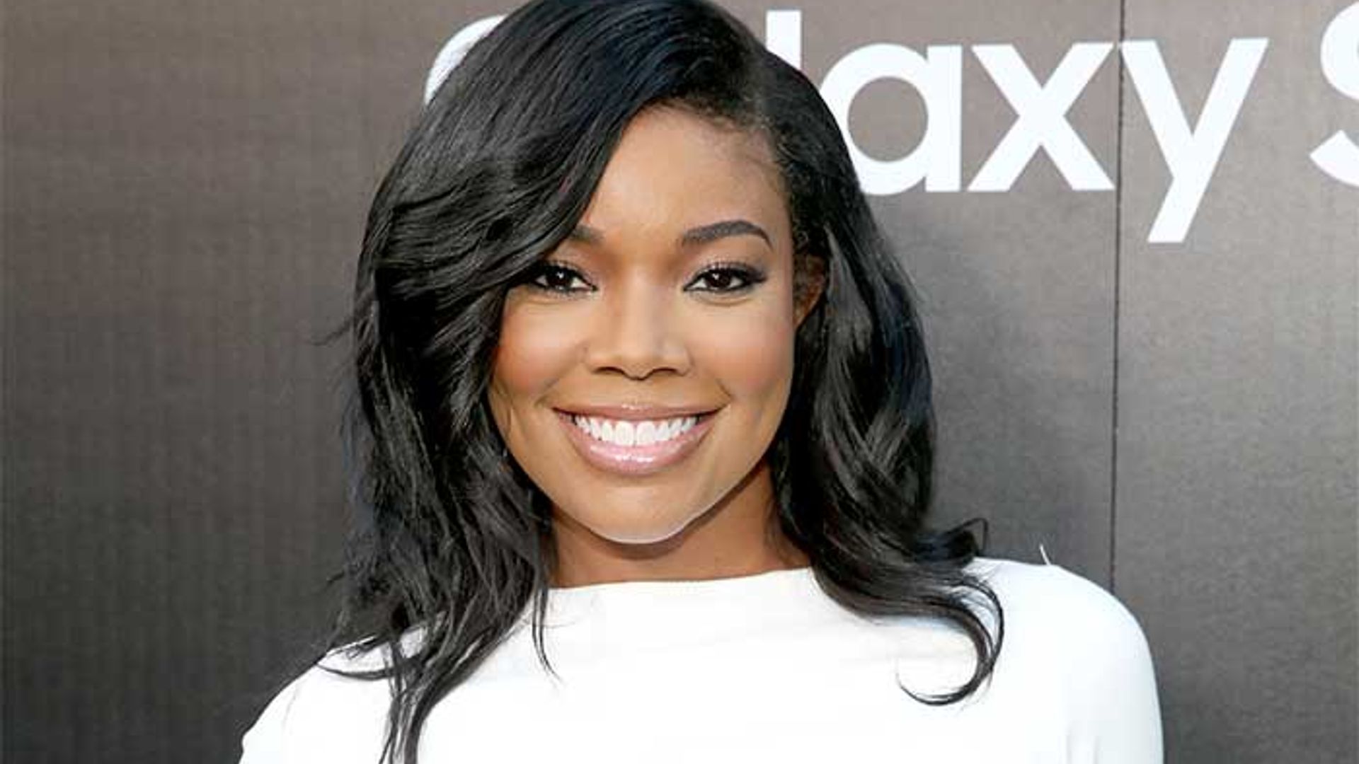 Gabrielle Union wows in a leather bra top for flirty poolside photo
