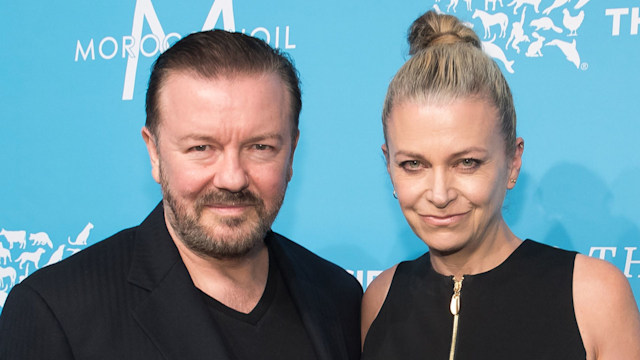 Ricky Gervais and Jane Fallon with blue backdrop