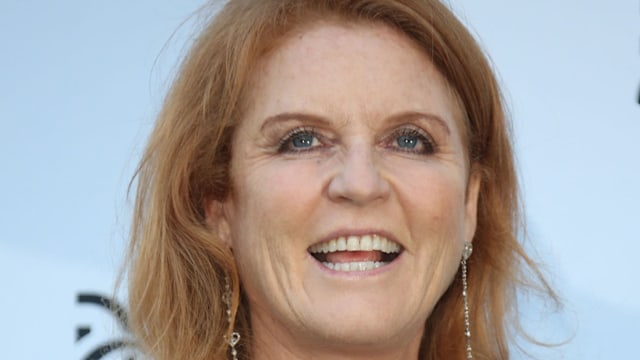 Sarah Ferguson smiling in a navy blue dress