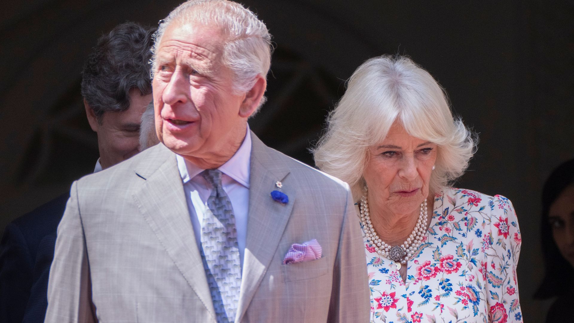 King Charles III and Queen Camilla wearing suit and dress