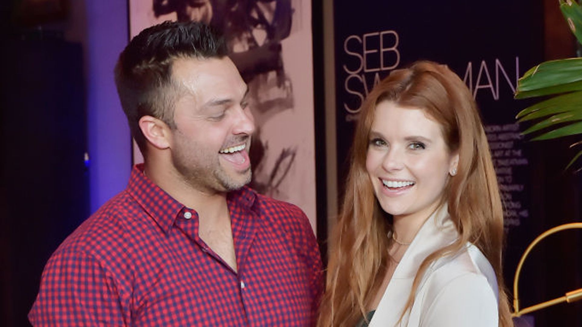 JoAnna Garcia and Nick Swisher cuddled up at an event. 