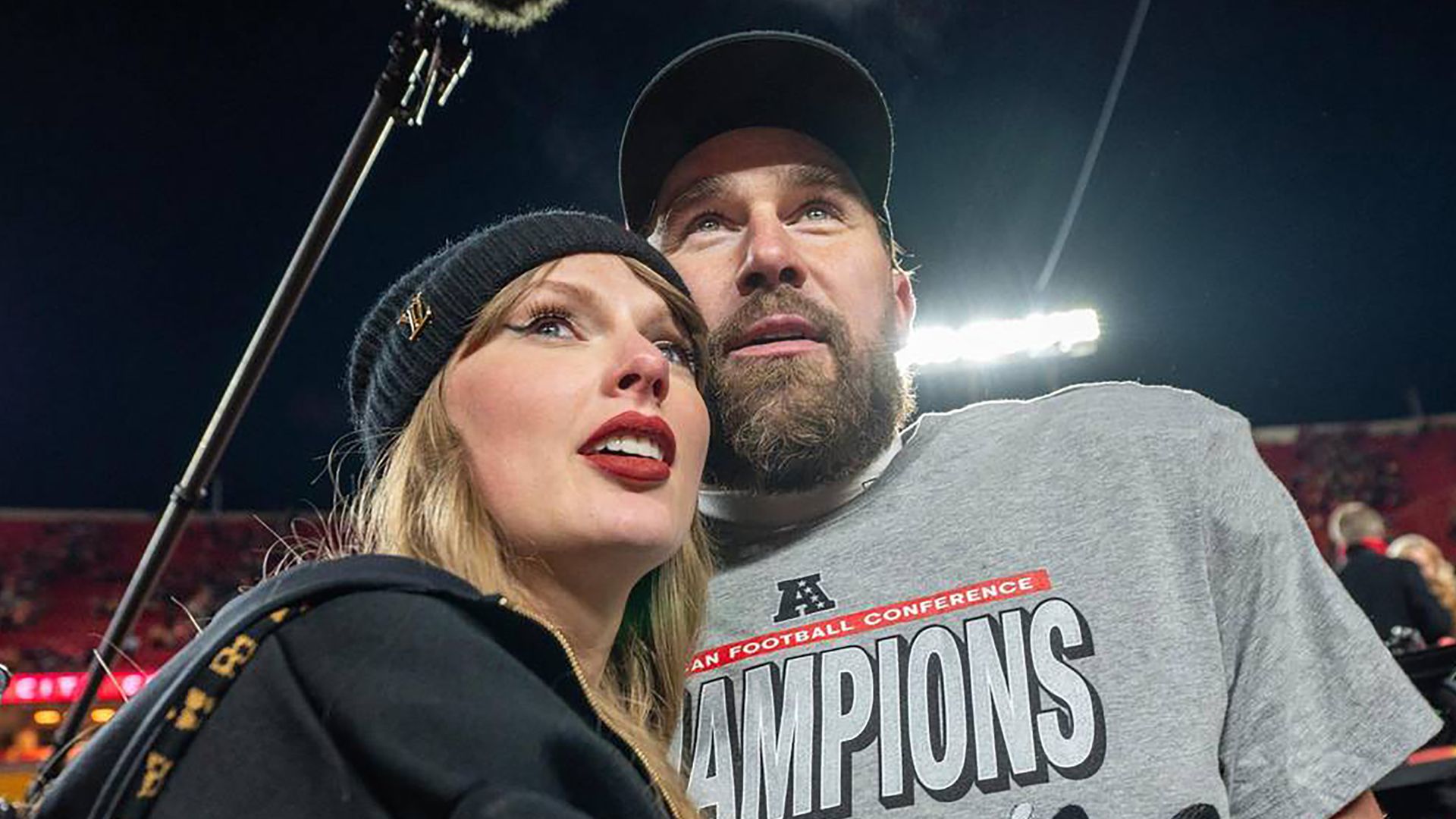 Taylor Swift and Kansas City Chiefs tight end Travis Kelce (87) walk off the field after the trophy ceremony following the Chiefs 32-29 victory over the Buffalo Bills in the AFC Championship Game on Sunday, Jan. 26, 2025, at GEHA Field at Arrowhead Stadium