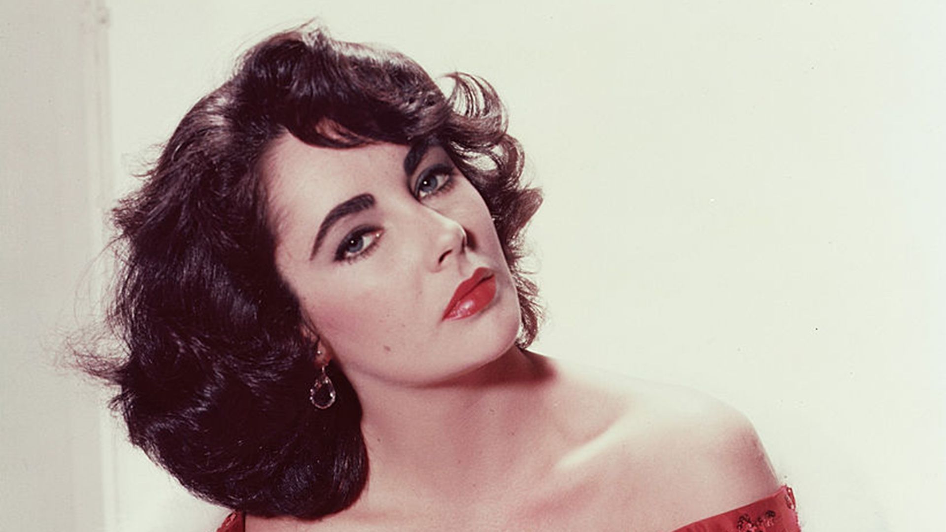 Elizabeth Taylor poses in a red dress 