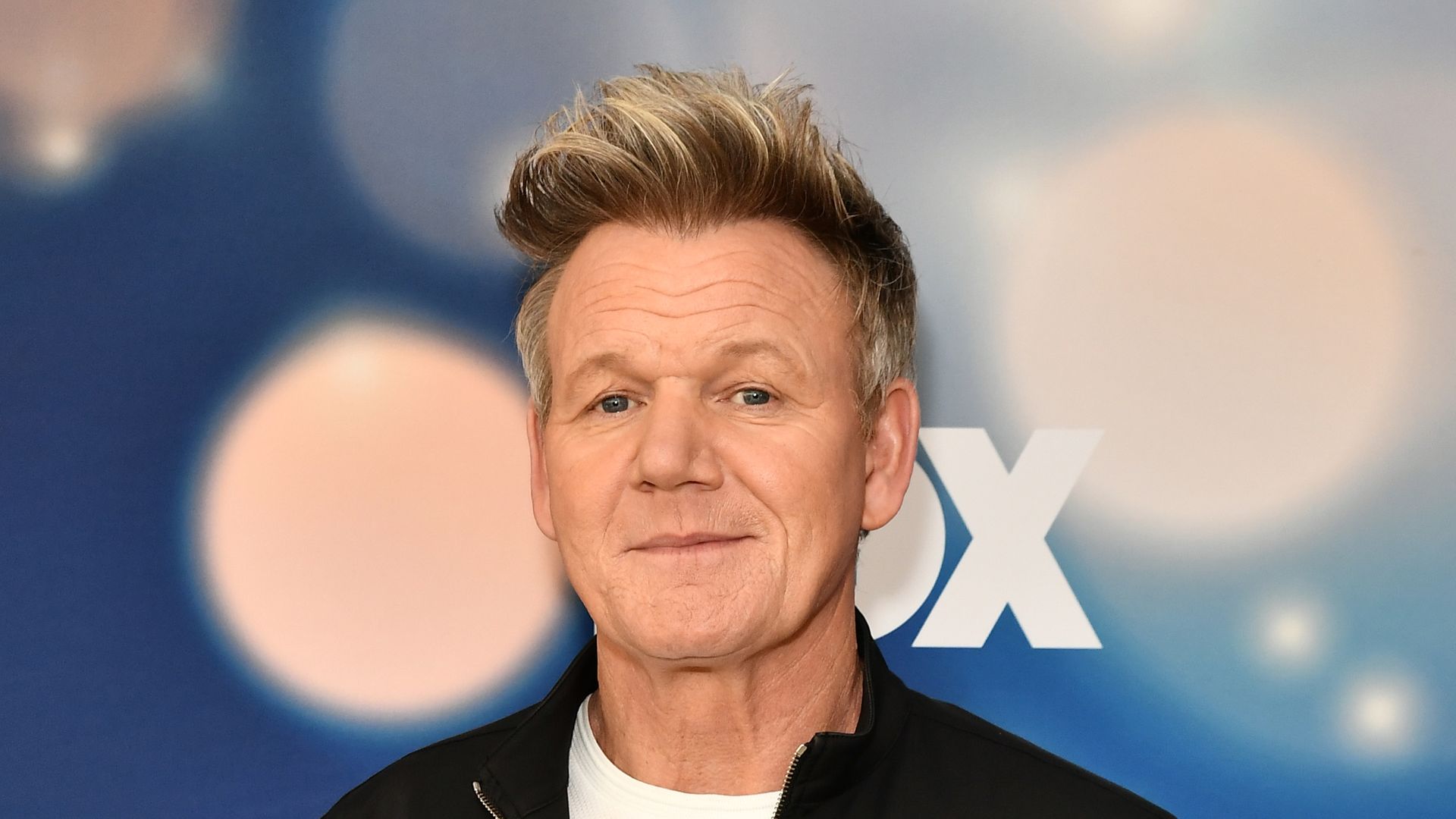 Gordon Ramsay in a black jacket and jeans