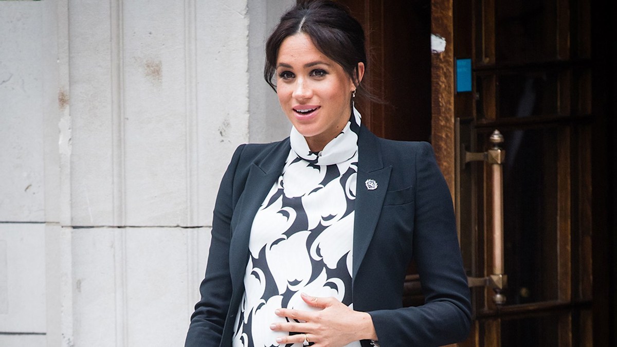 Meghan Markle cradles baby bump in beachwear in neverbeforeseen photo