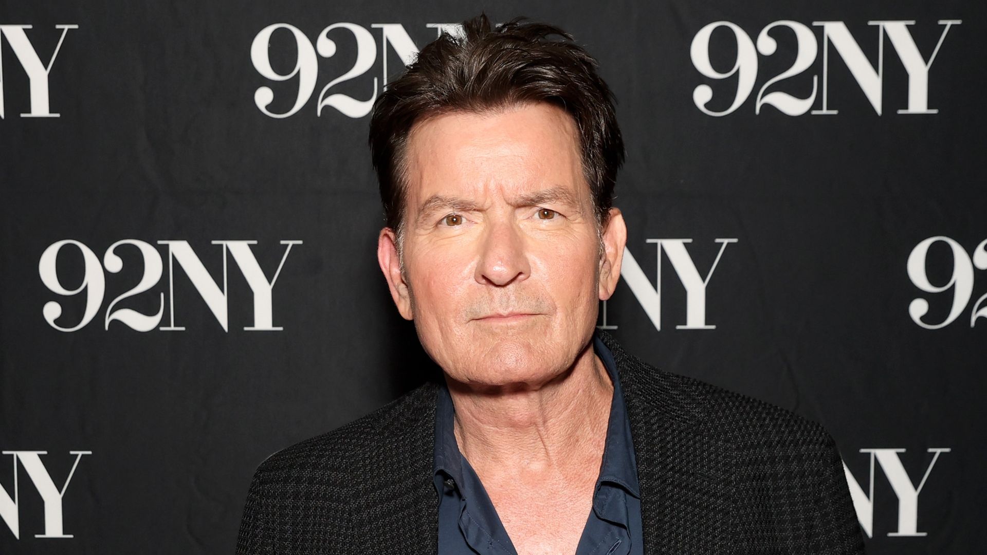 Charlie Sheen in black blazer at a conversation for his new book "The Book Of Sheen" with David Duchovny at 92NY 