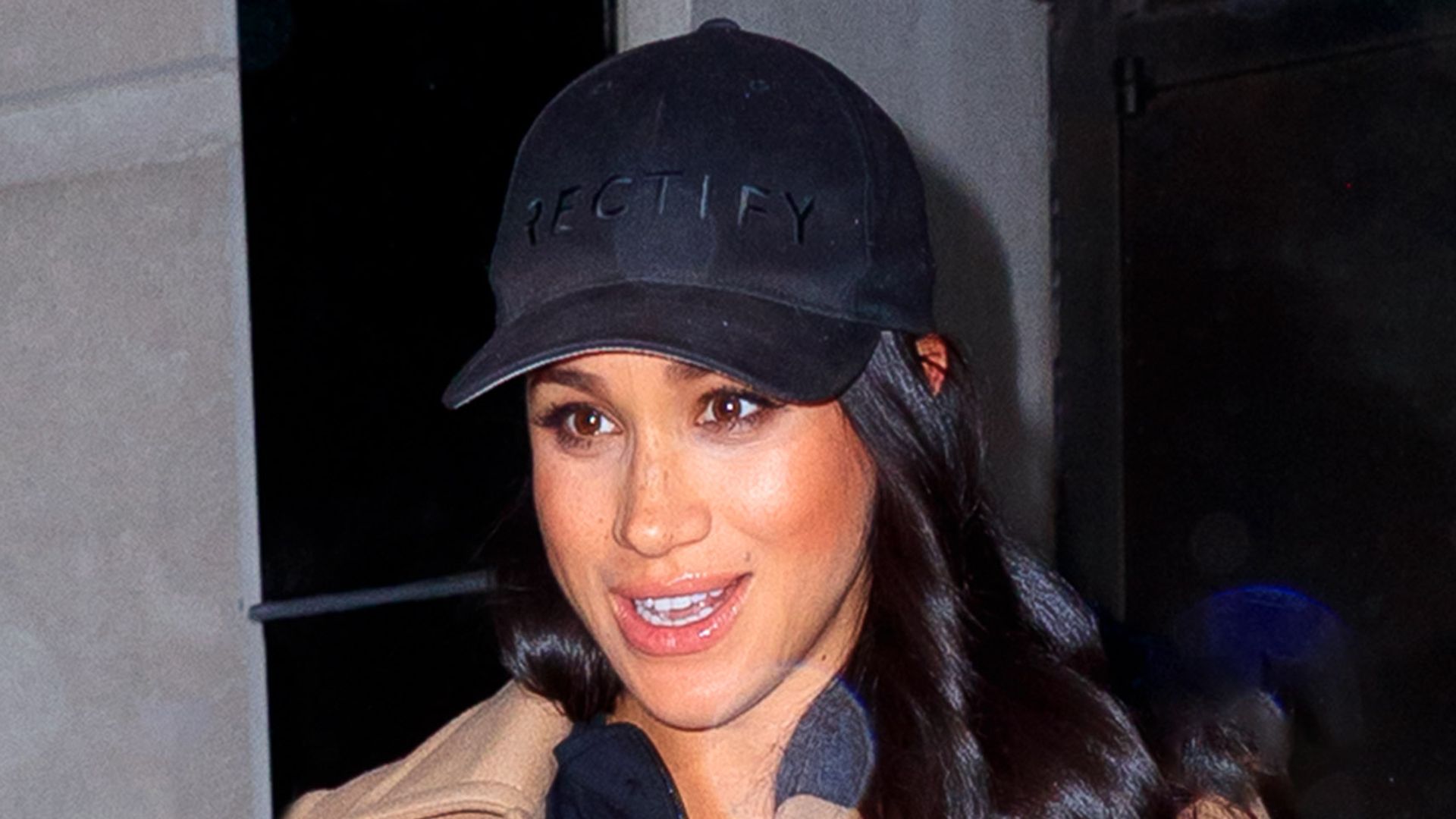 Meghan, Duchess of Sussex in cap and tan coat