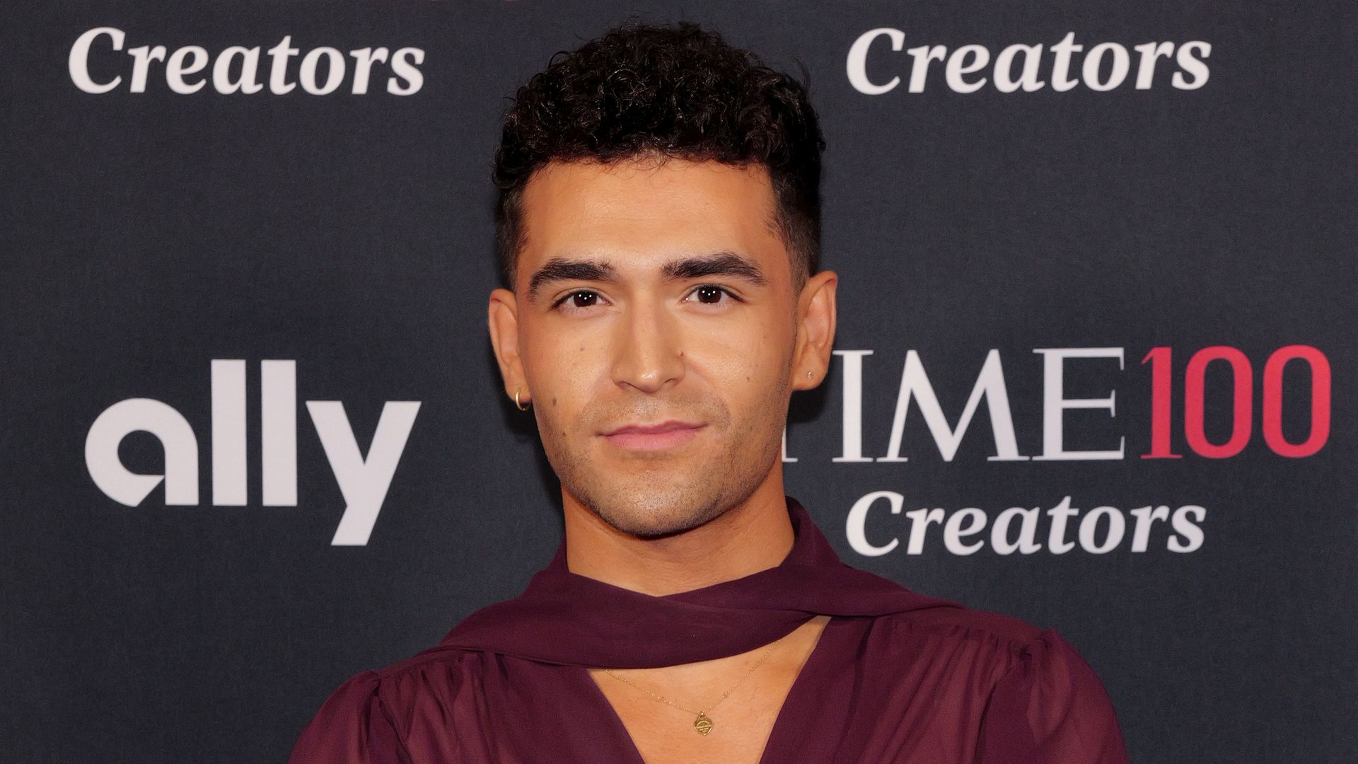 Ezra Sosa in burgundy top