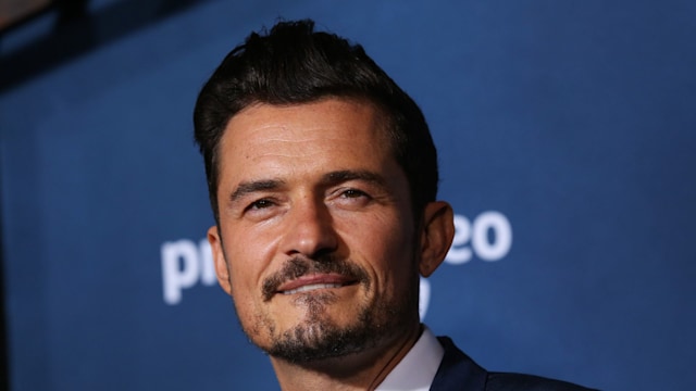 Orlando Bloom posing for camera in suit 