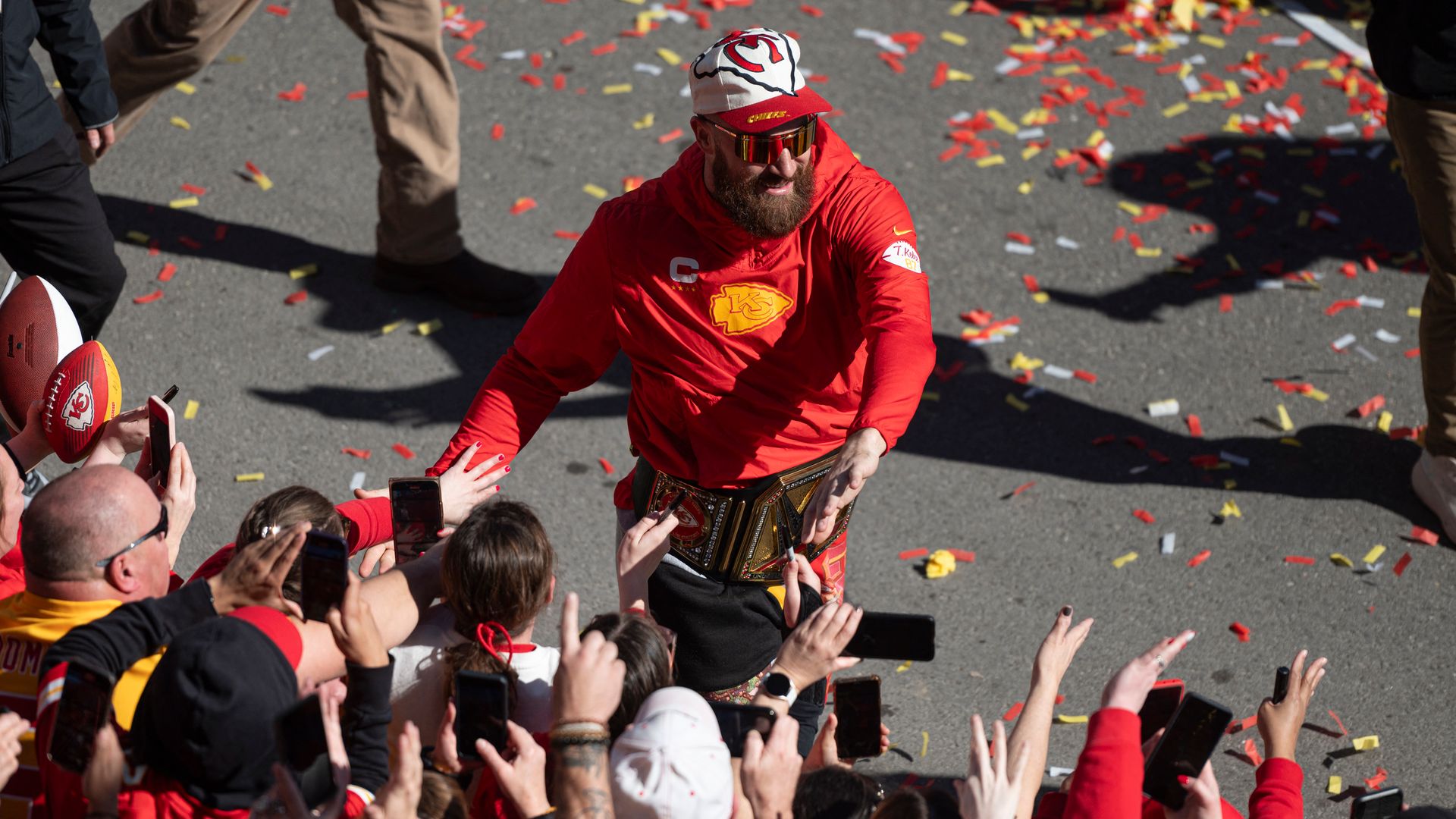Kansas City Chiefs tight end Travis Kelce high fives fans during the Chiefs' Super Bowl LVIII victory parade on February 14, 2024, in Kansas City, Missouri