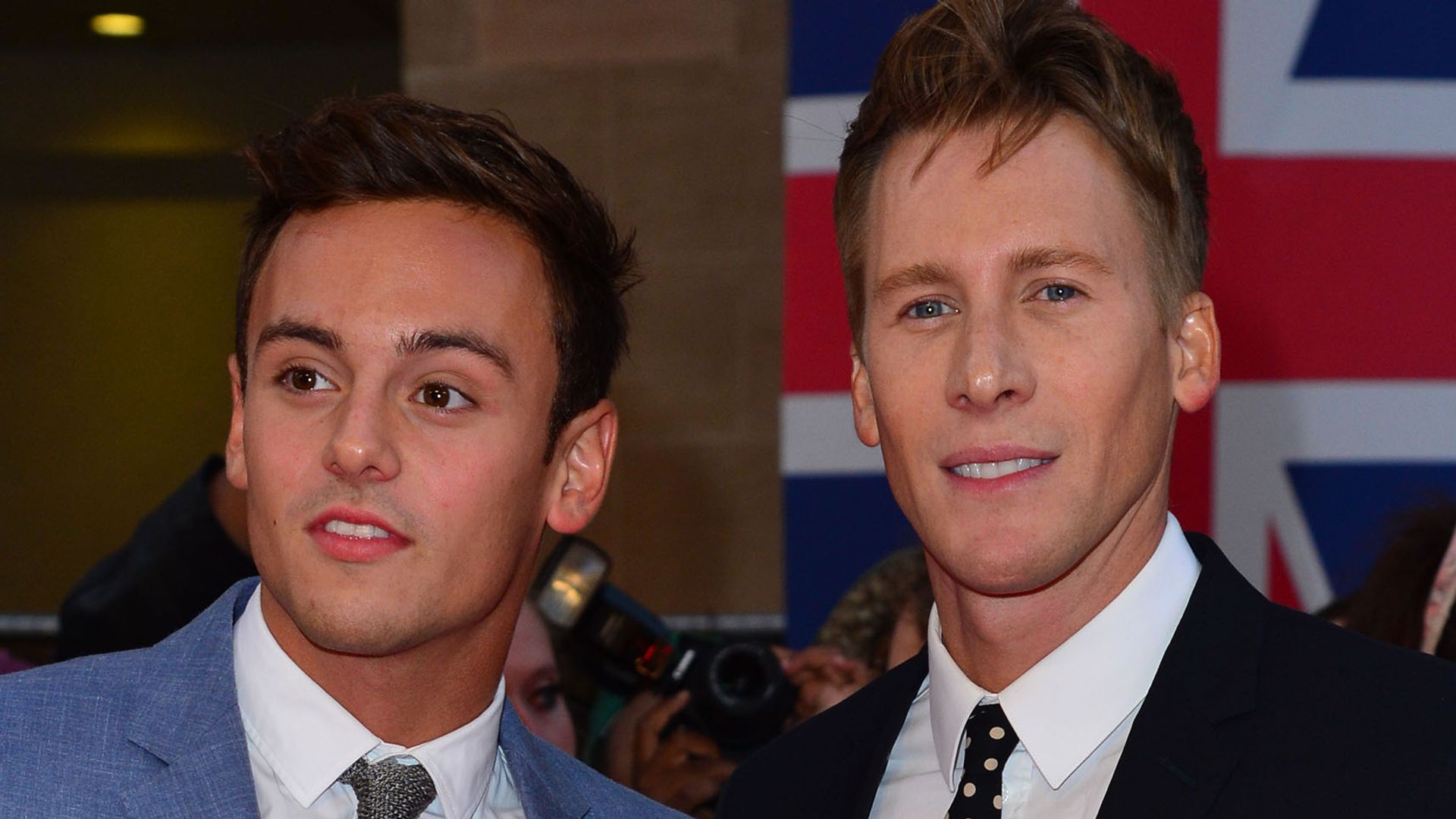 Tom Daley in a blue suit and Dustin Lance Black in a black suit