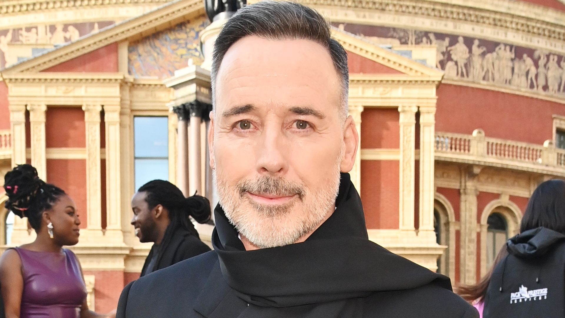 David Furnish smiling posing for a photo on the steps of the Royal Albert Hall