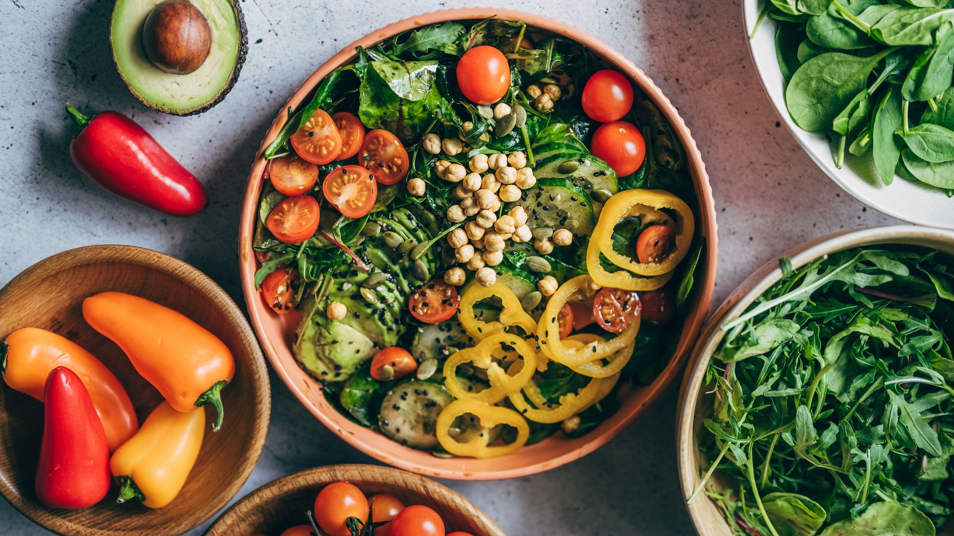 Close up of woman's hand holding a bowl of fresh beef cobb salad, serving on the dining table. Ready to enjoy her healthy and nutritious lunch with coffee. Maintaining a healthy and well-balanced diet. Healthy eating lifestyle