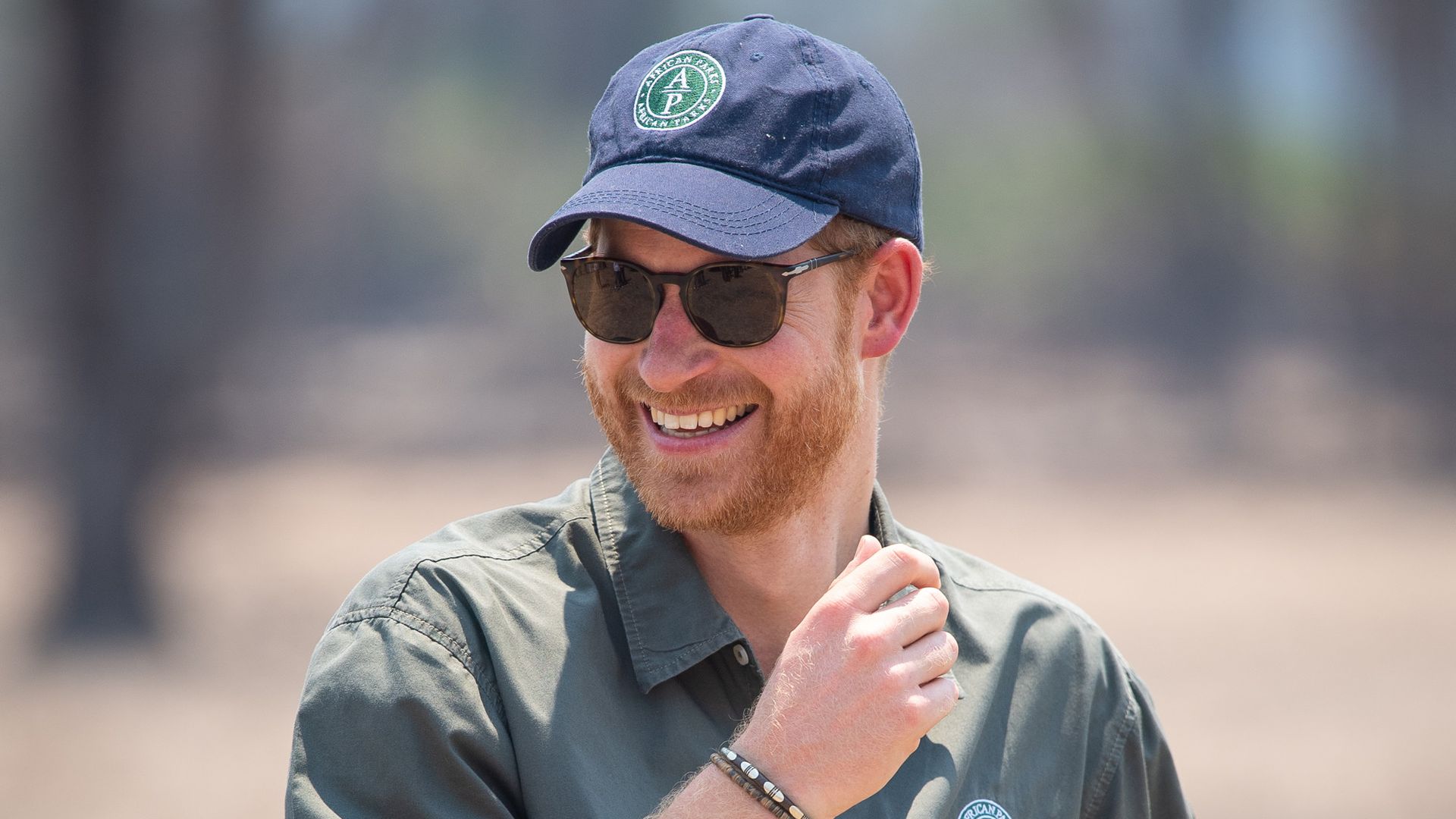 Prince Harry smiling and wearing African Parks cap in 2019