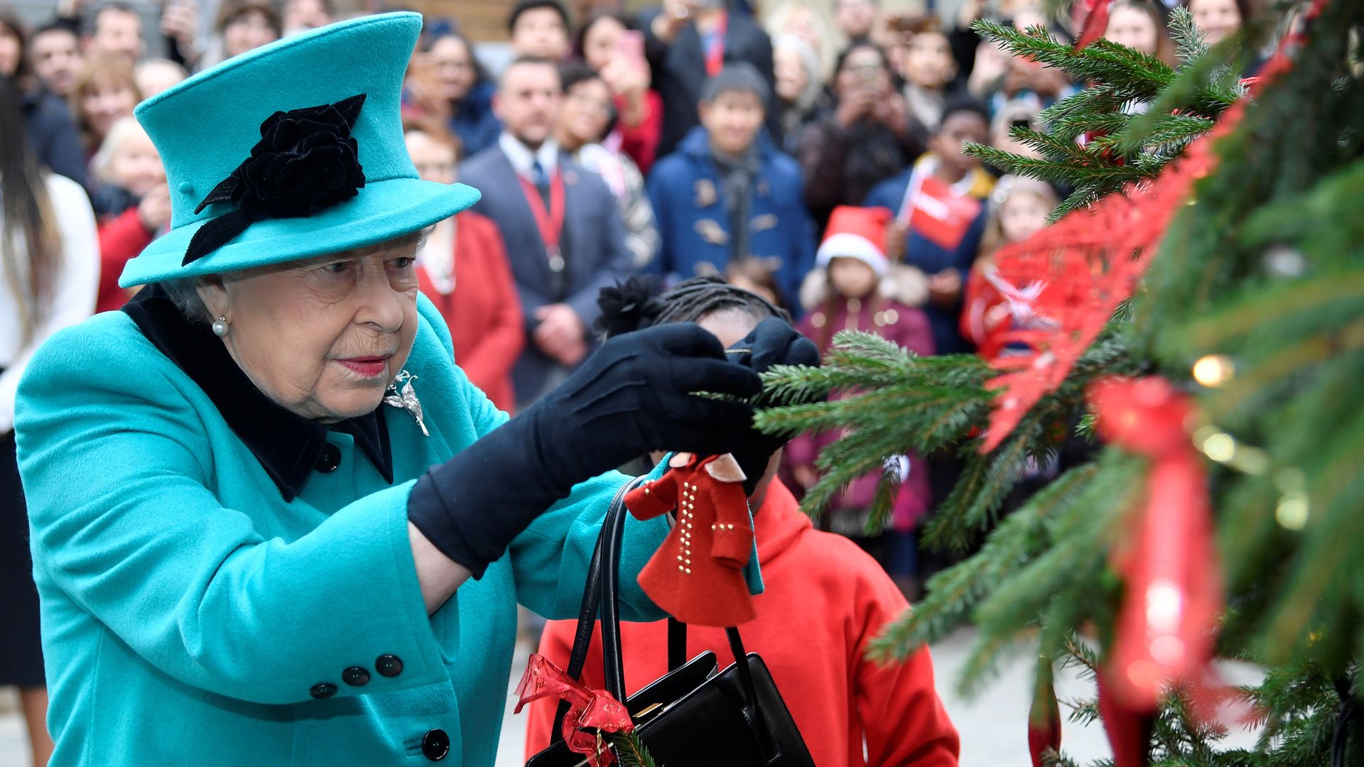 late queen decorating christmas tree